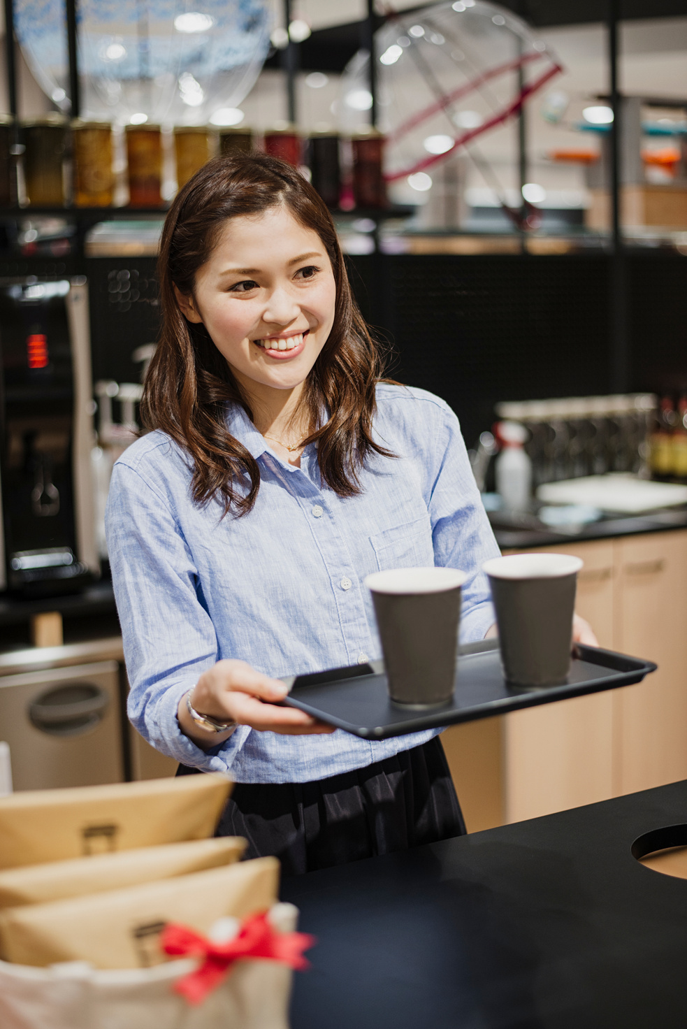Woman cafe clerk standing at the counter